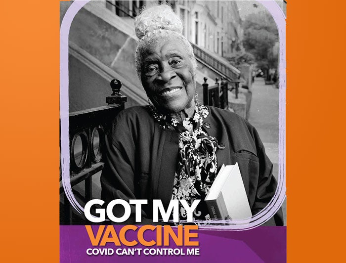 Woman holding book, framed in a picture with the title saying got my vaccine.