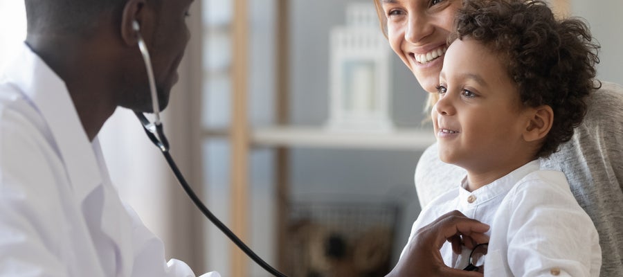 Young child with stethoscope on chest