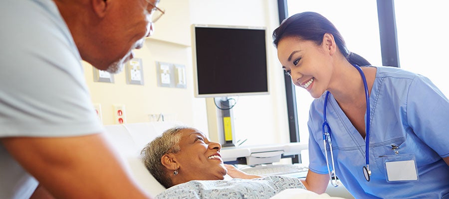 Release 2026.2. A clinician talking to an older black female in a hospital room.